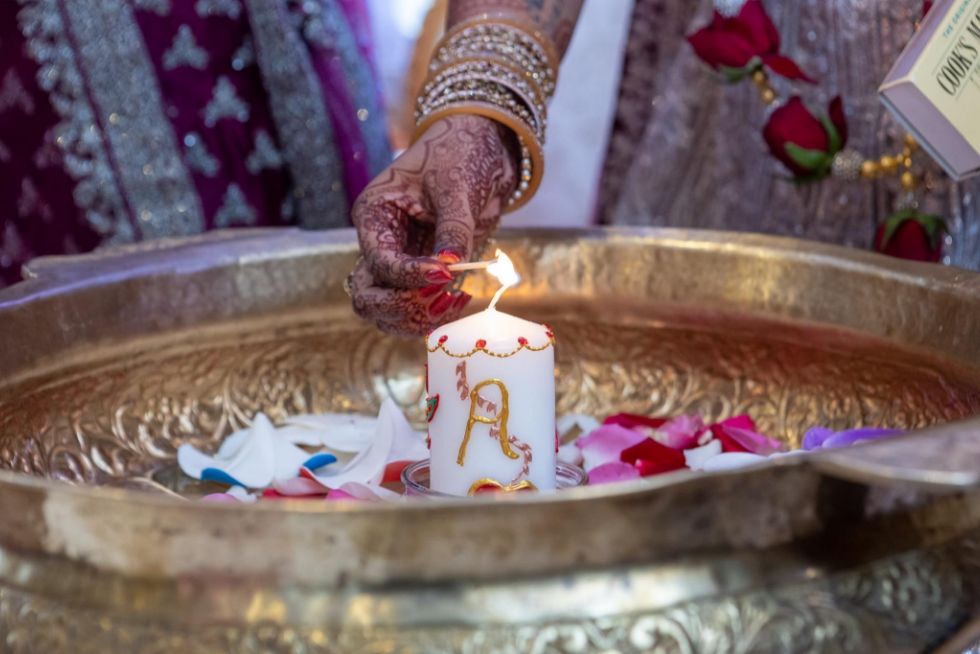 hand lighting a candle