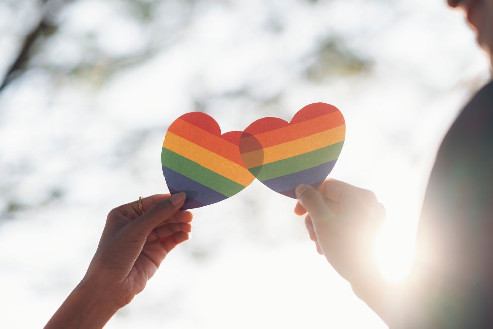 lgbtq-weddings-breaking-traditions-1 hands holding rainbow hearts